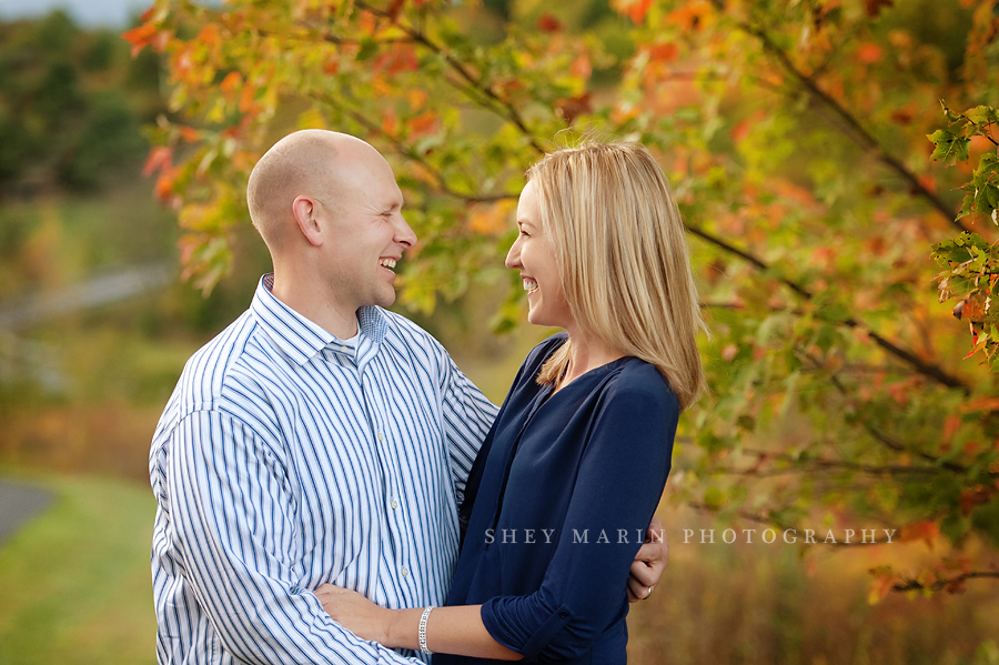 loving smiling couple in fall leaves