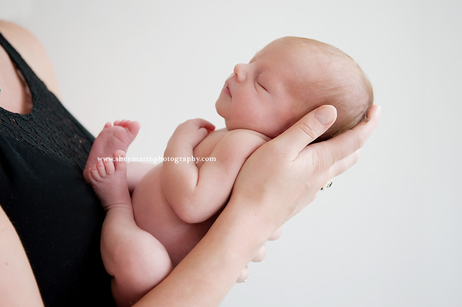 newborn baby in mothers arms