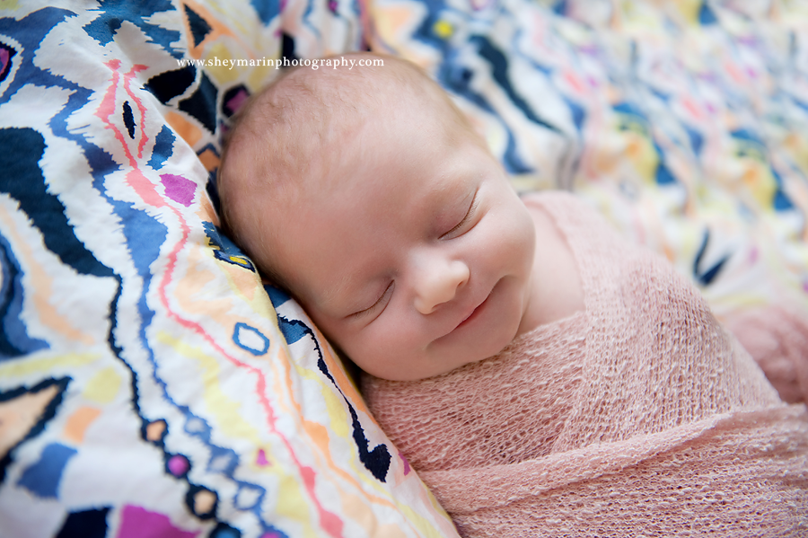 newborn baby girl on modern blanket