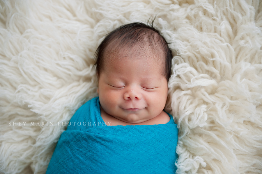 newborn baby wrapped in teal