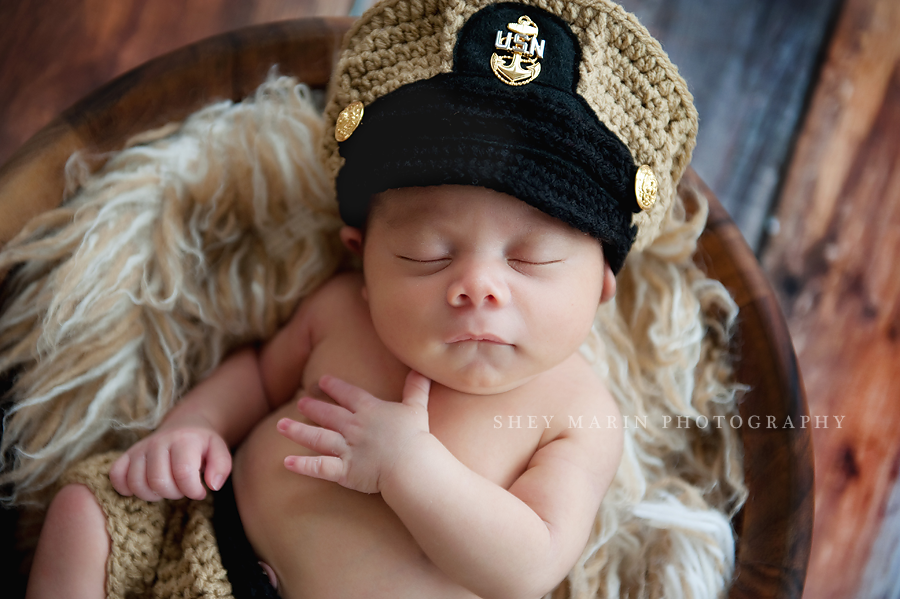 newborn baby boy in US Navy hat