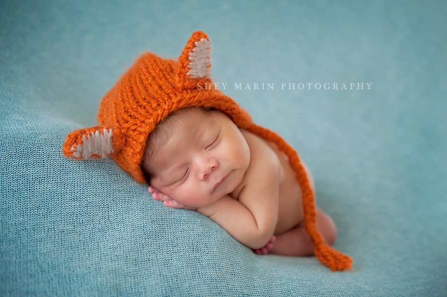 newborn baby boy in orange fox hat