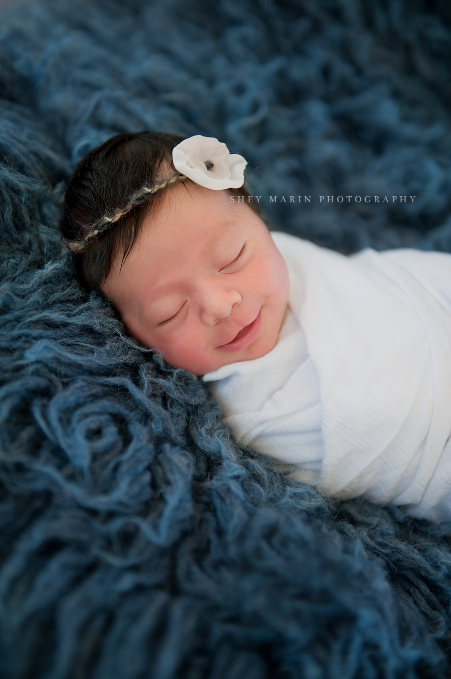 newborn baby girl on blue blanket