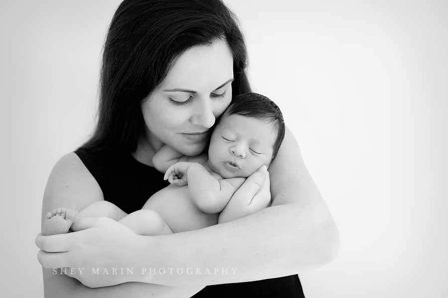 black and white of mother holding newborn baby