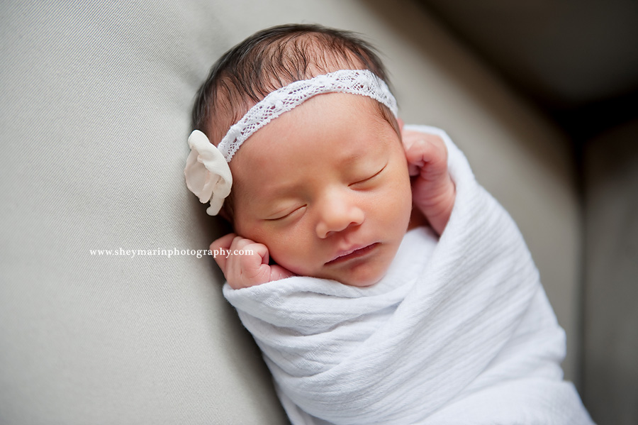 newborn baby wrapped in white