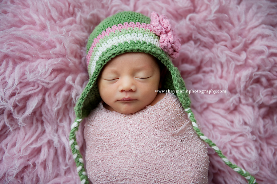 newborn baby girl on pink fur
