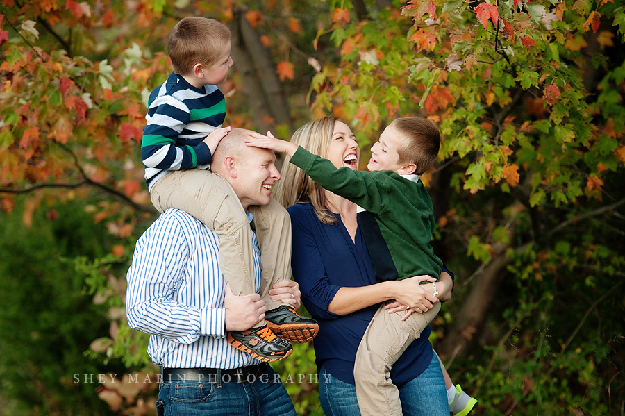 laughing family in fall trees