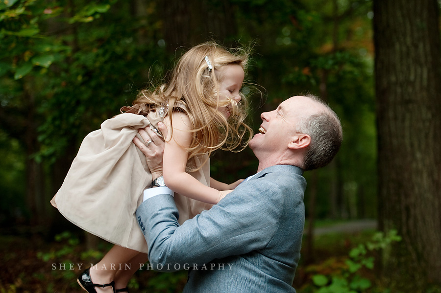 little girl being thrown in the air by her father