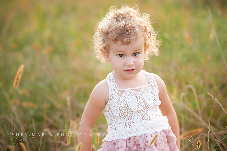 little girl in a grassy field
