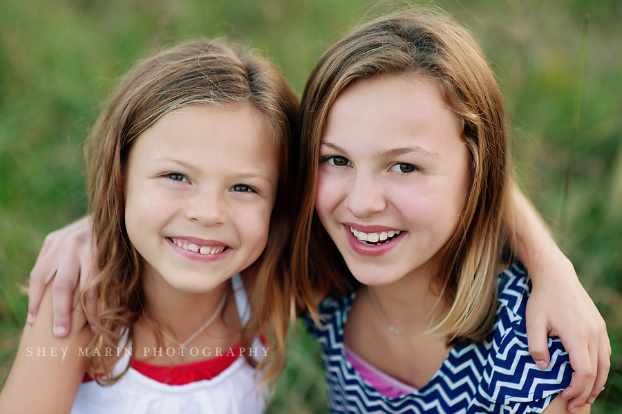 two sisters smiling together