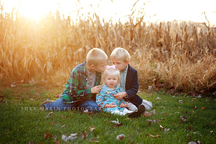 three kids in a corn field