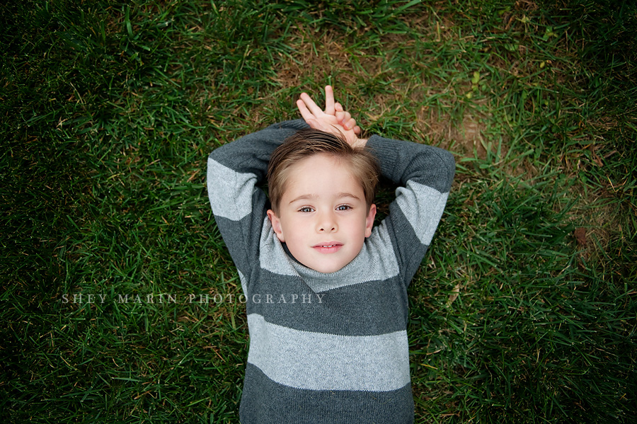 Frederick boy lying in grass