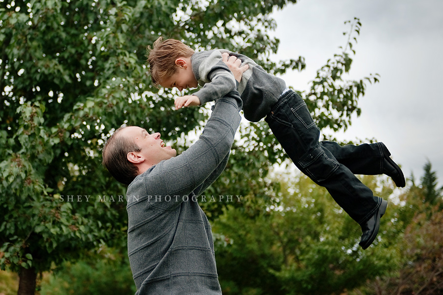 Dad throwing boy into the air