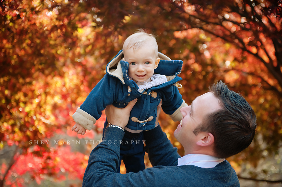 baby boy in red fall leaves in washington DC