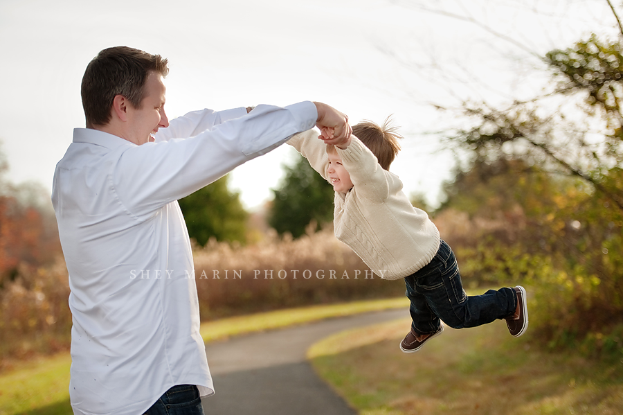 little boy being spun by daddy