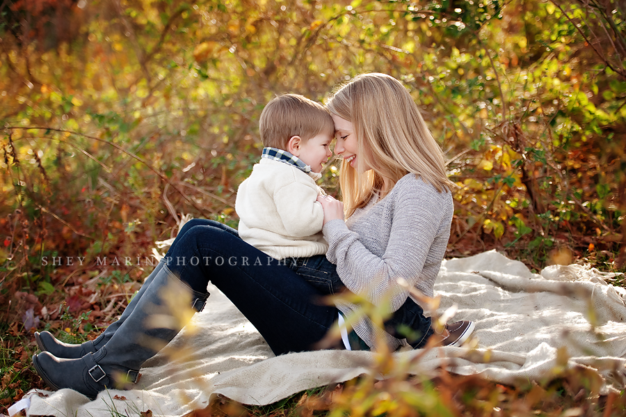 mom and little boy touching foreheads