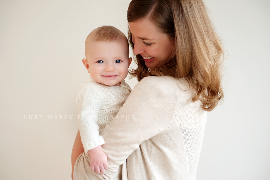 studio image of mother holding baby boy