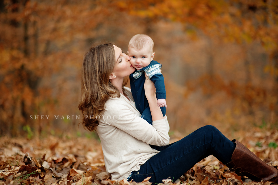 gorgeous mother and baby boy in fall foliage