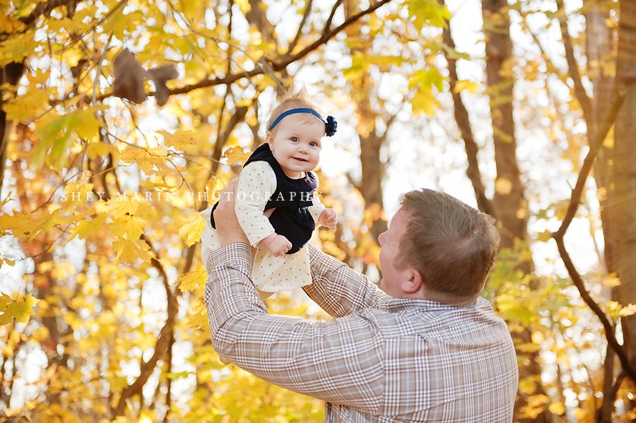 girl with dad in yellow leaves