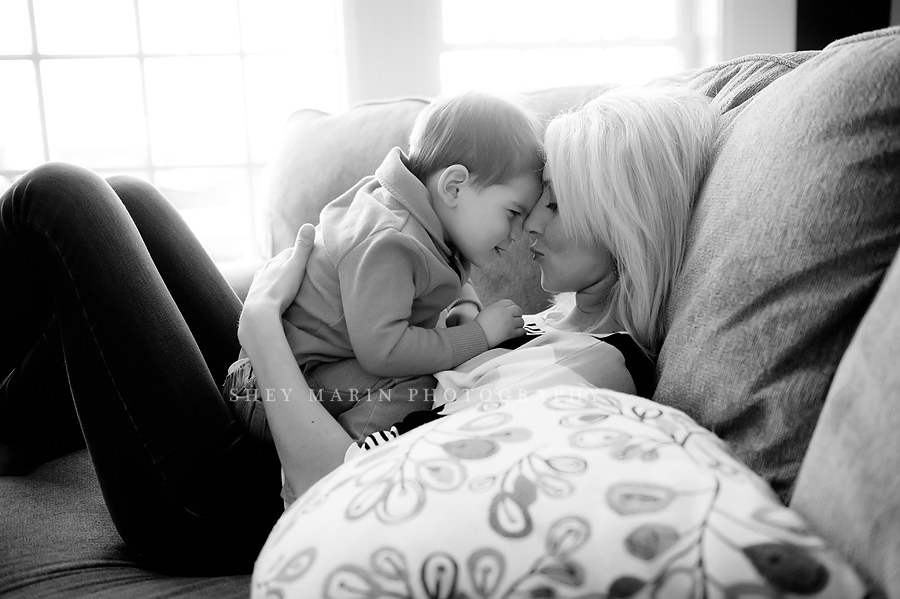 black and white photo of mom and son cuddling