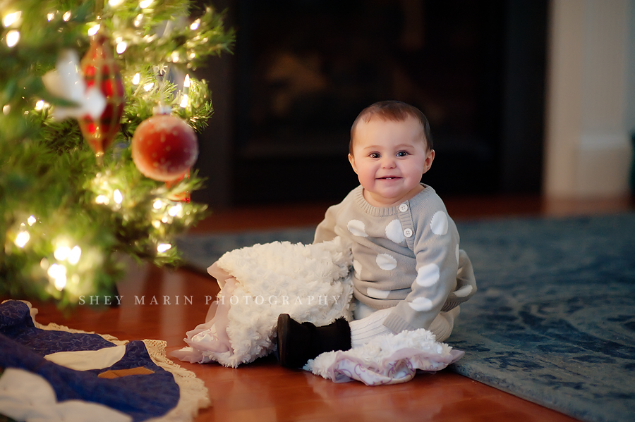 Baby girl in front of Christmas tree