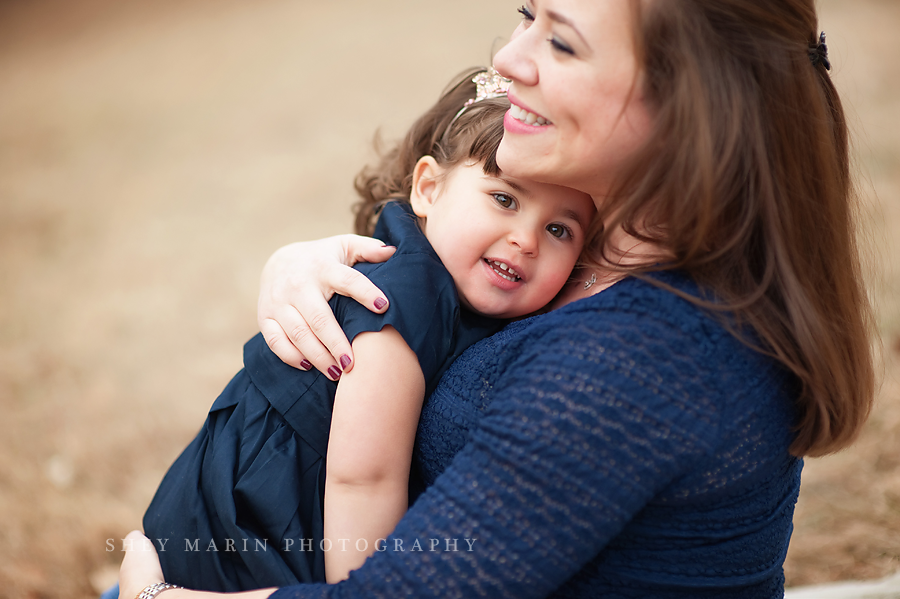 little girl cuddling on smiling mom in Washington DC photosession