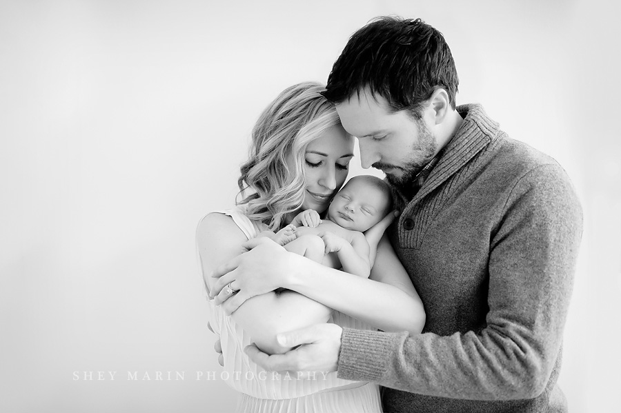black and white photo of family with newborn baby