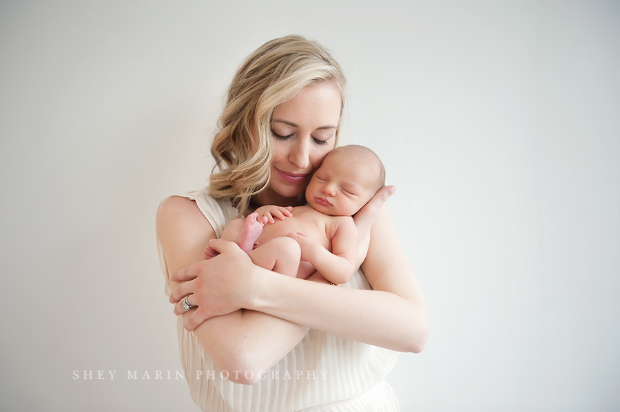 beautiful mother holding newborn baby girl