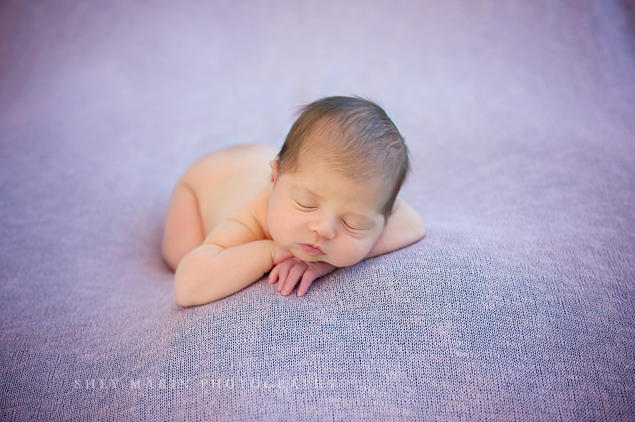 newborn baby girl on lavender blanket