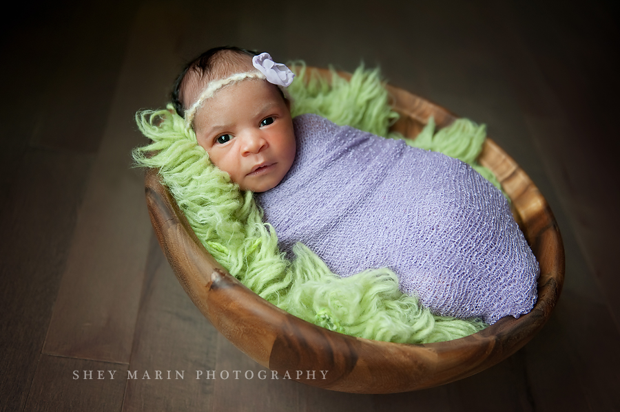 newborn baby in wooden bowl