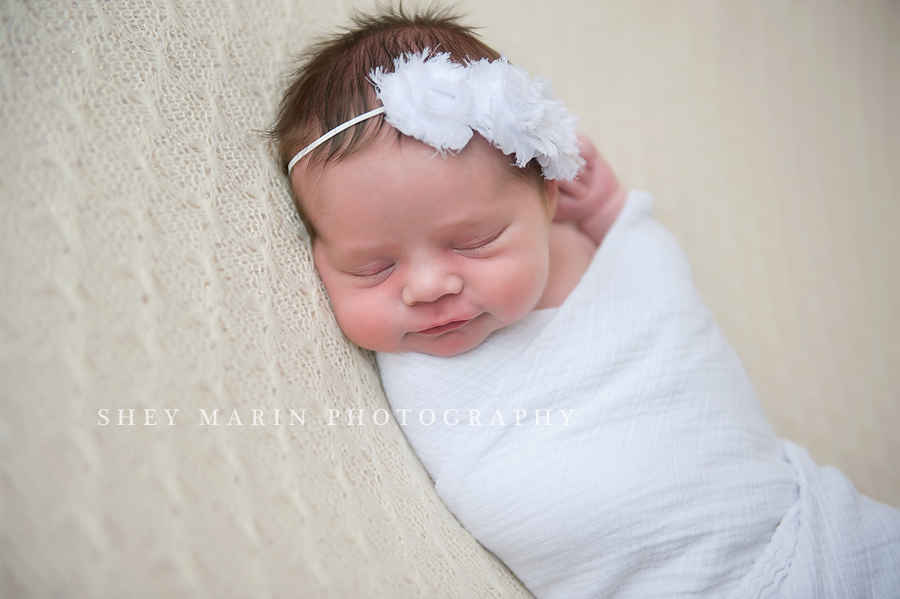newborn baby girl in white headband