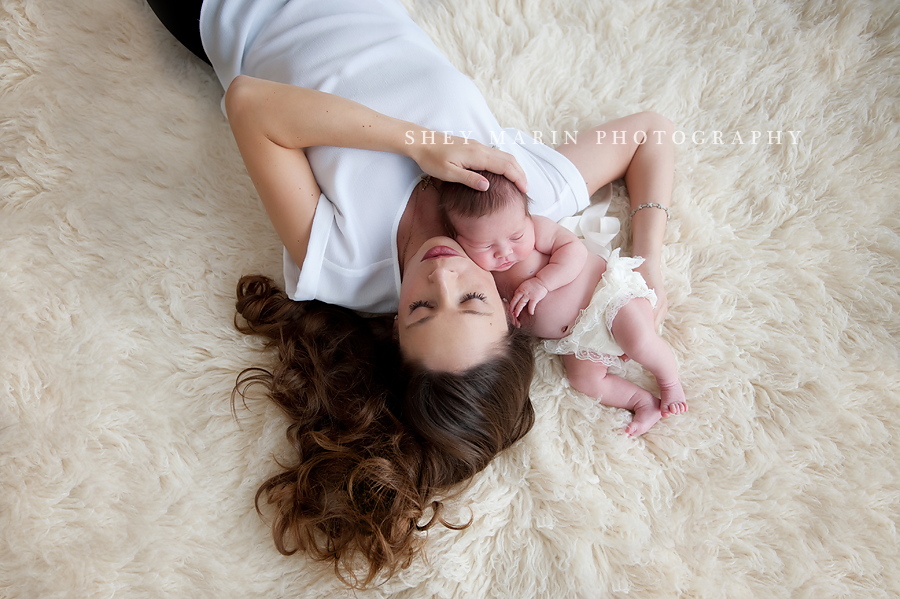 mother and newborn lying on floor with eyes closed
