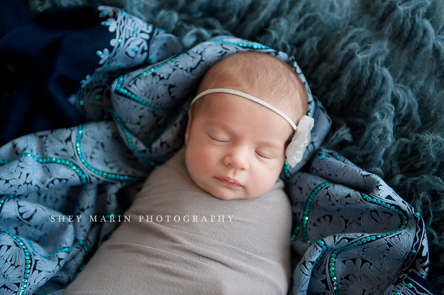 baby girl newborn in blue blankets