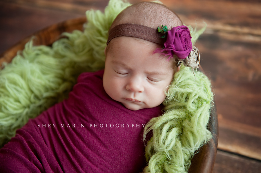baby girl in magenta and green blankets