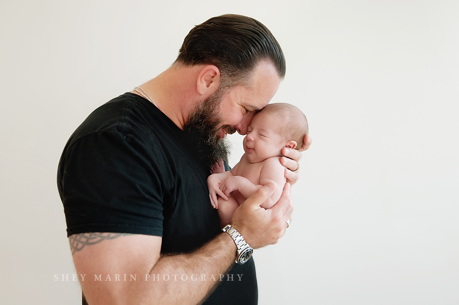 military father holding new daughter