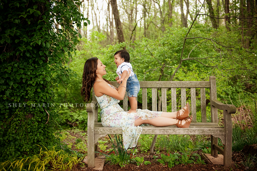 laughing boy and mom on a bench