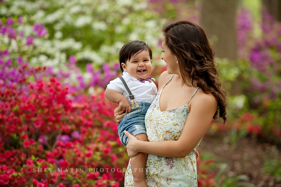boy smiling in mom's arms with azaleas 