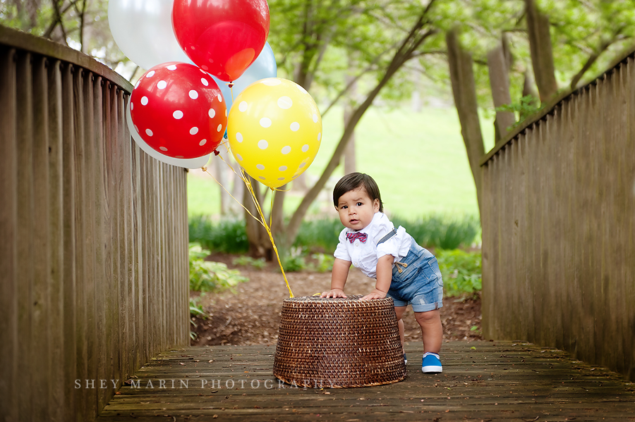 boy with balloons on a bridge