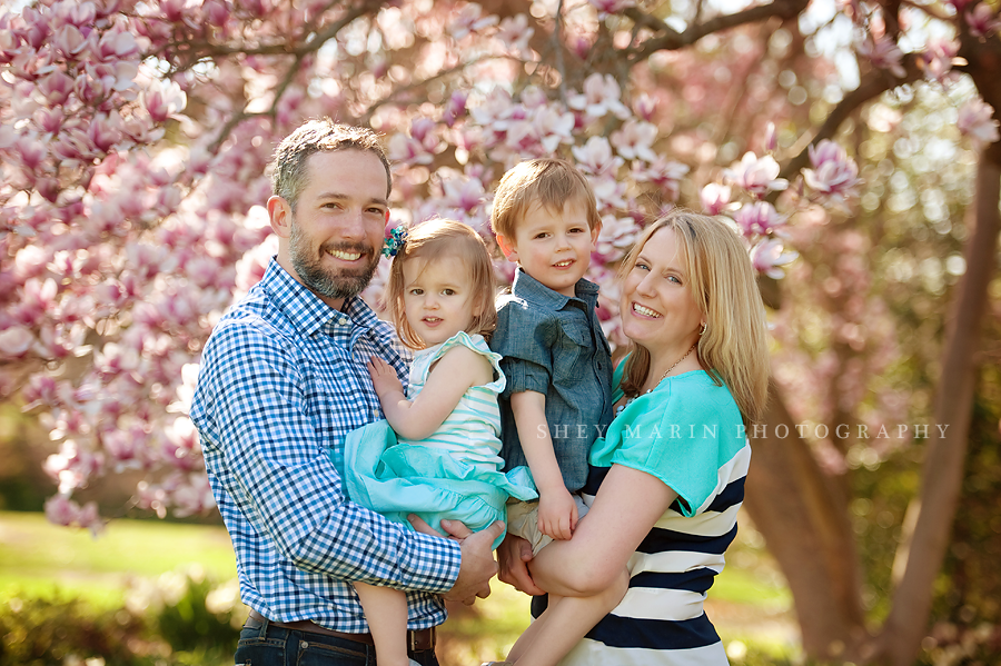 happy family smiling in cherry trees