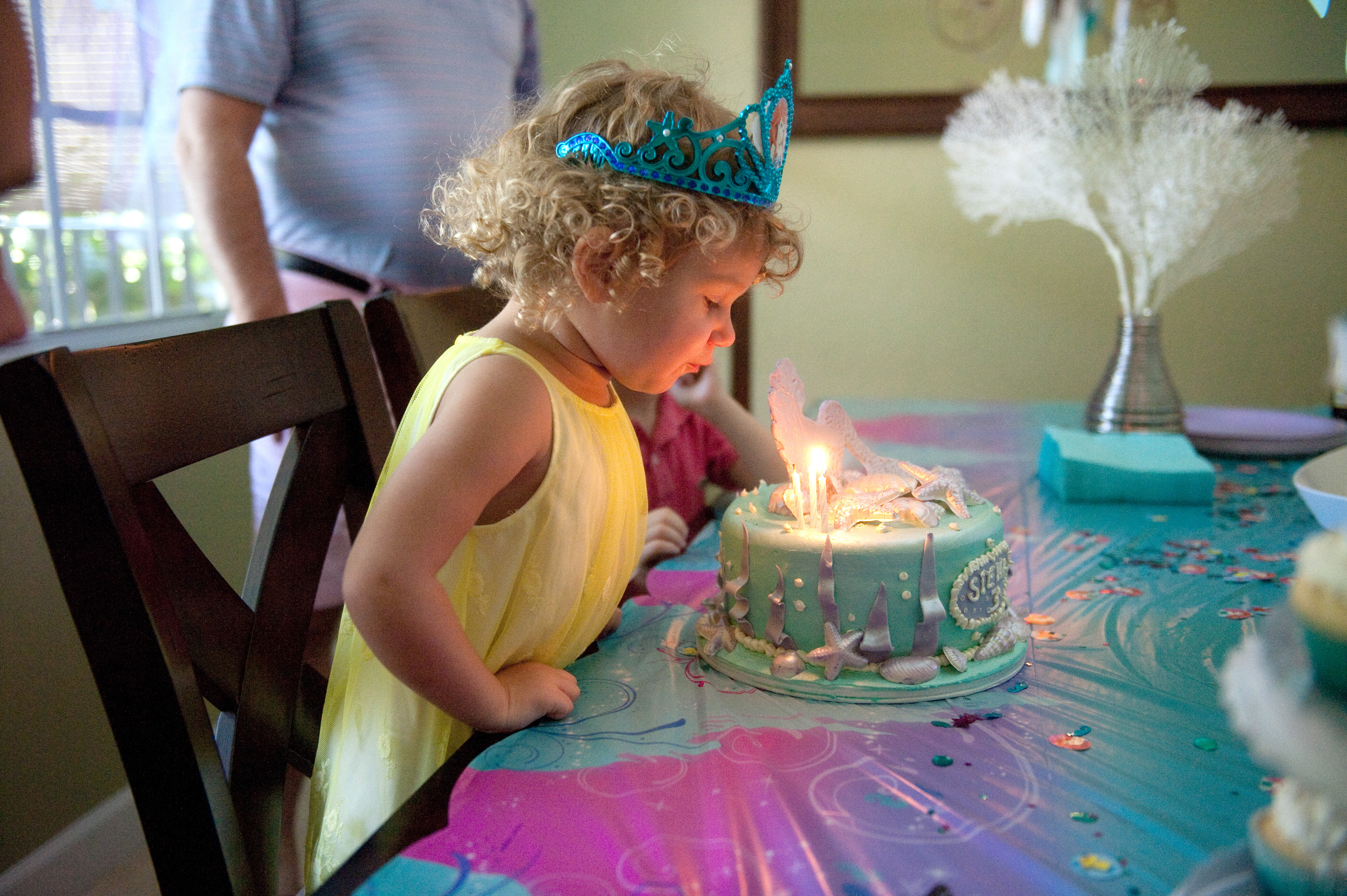 girl blowing out her candles