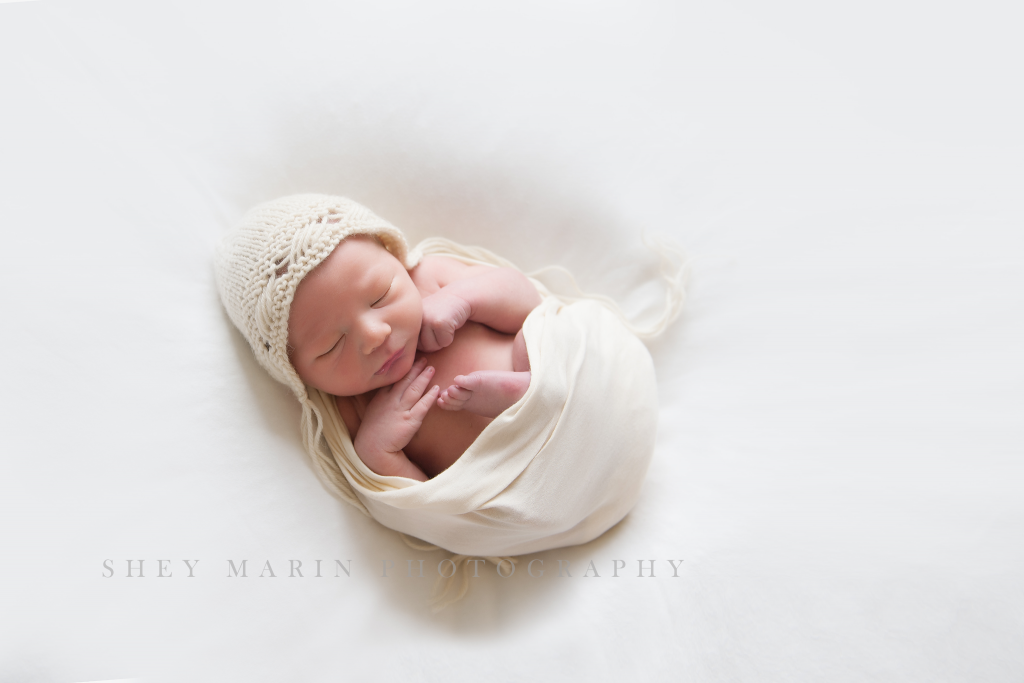 newborn baby on cream wrap in frederick maryland