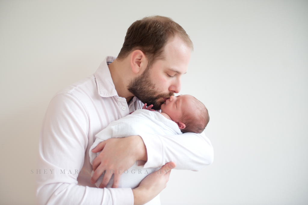Washington DC newborn held in dads arms