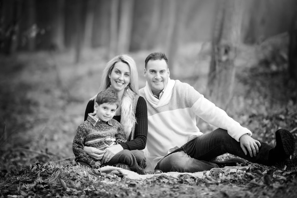 black and white photo of boy and family in forest | frederick family photographer