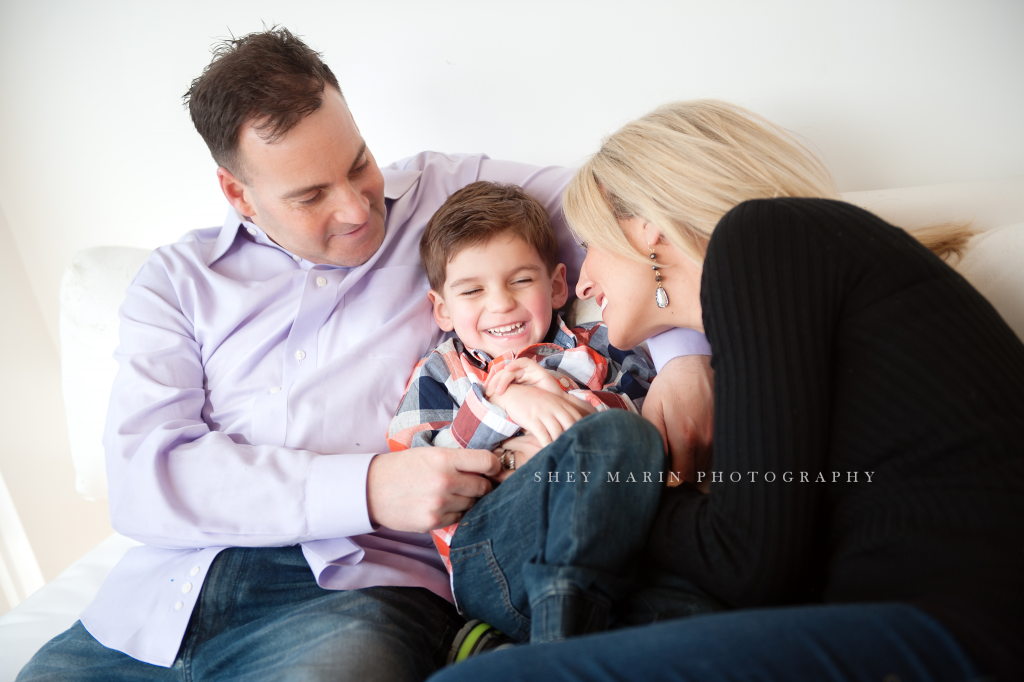 boy and parents lifestyle image laughing | frederick family photographer