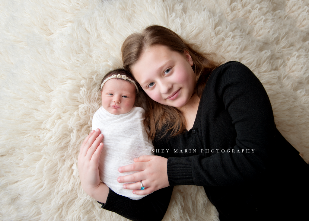 big sister holding baby sister | Frederick Maryland newborn photographer 