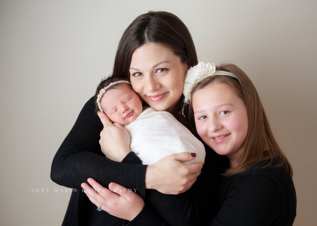 mom holding baby and older sister | Frederick Maryland newborn photographer 