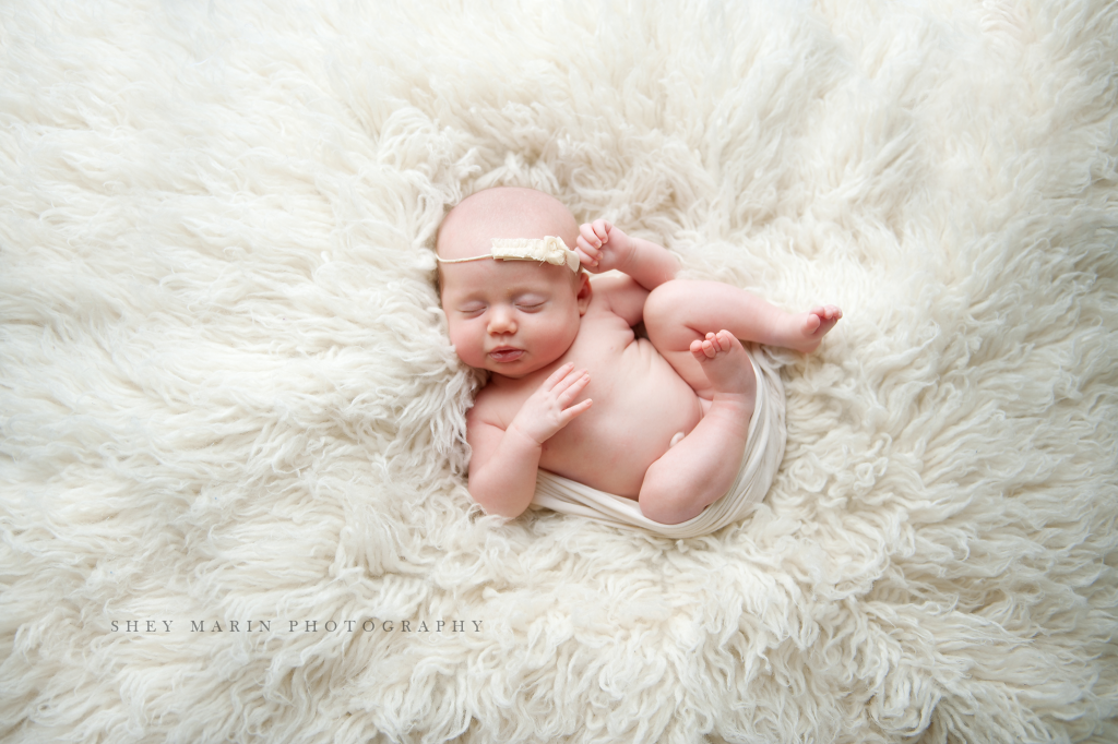 baby girl on white fur | Washington DC multiples newborn photographer