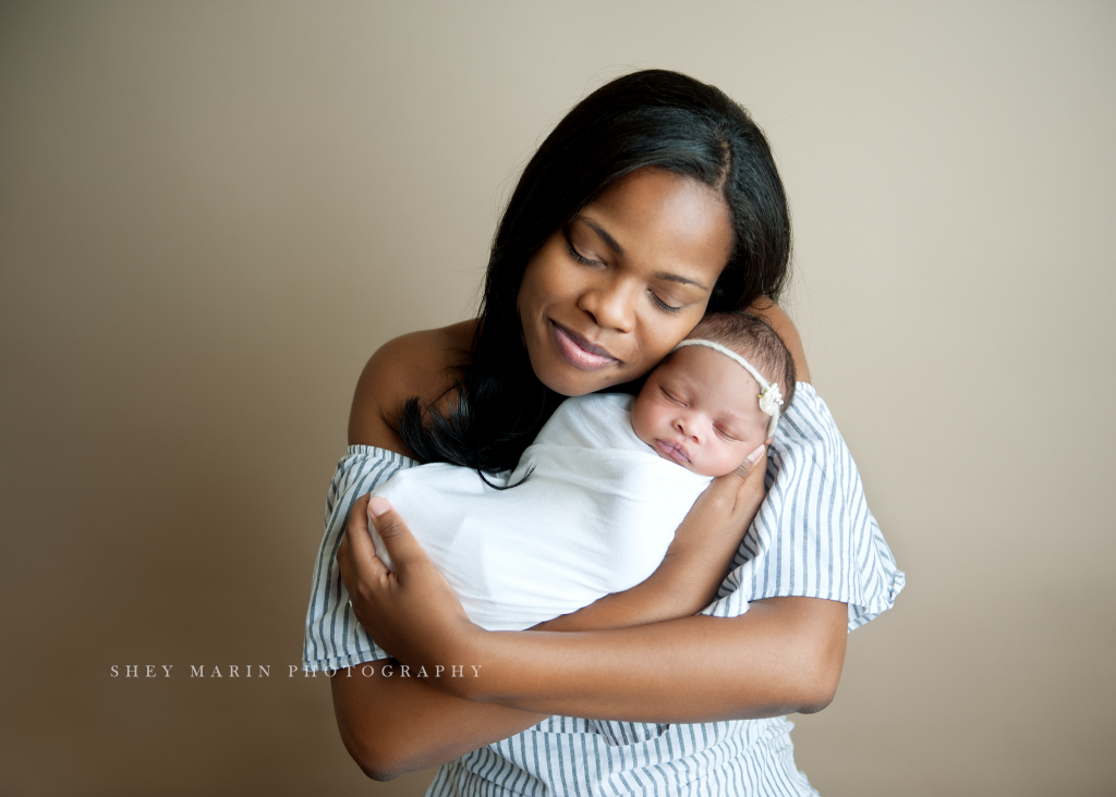 mommy holding baby girl with eyes closed | Washington DC newborn photographer