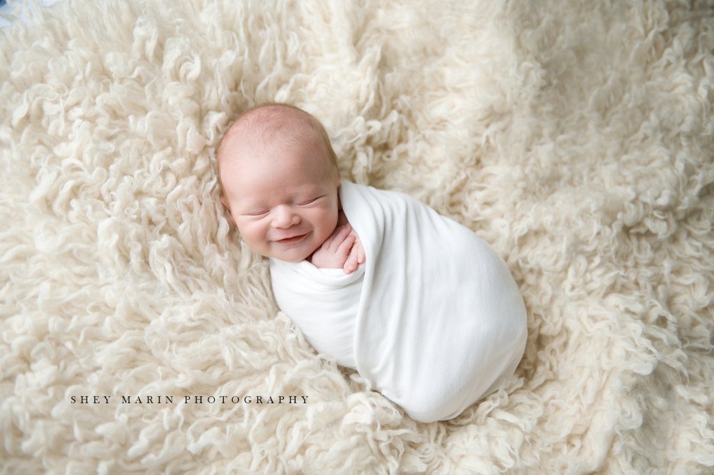 newborn baby boy smiling