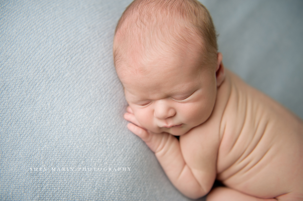 newborn baby boy on blue blanket